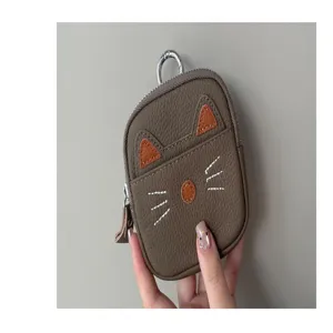 Detail shot of cute cat leather coin purse, mini wallet with keychain and zipper closure.