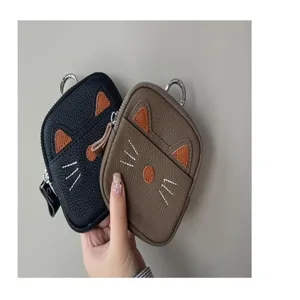 Close-up detail of cute cat shape coin purse, leather texture and zipper design, mini key pouch.