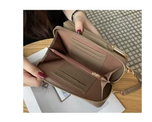 Detailed view of the women's genuine leather phone bag, showing interior card slots and zipper.