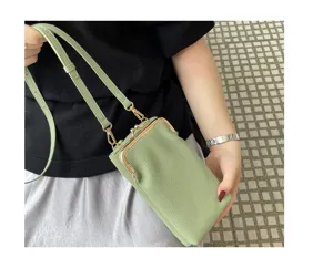 Detail view of light green leather kiss-lock phone bag, showcasing fine texture and clasp.