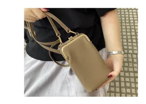Detailed view of genuine leather mini crossbody phone bag with metal kiss-lock closure.