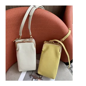 Close-up detail of genuine leather mini crossbody phone bag with kiss-lock metal closure.