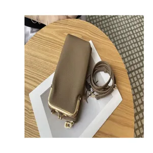 Genuine leather women's mini phone bag detail shot, stylish crossbody kiss-lock small pouch.