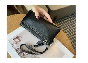 Genuine leather long clutch bag, black pebble grain, portable phone wallet detail view.