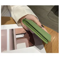 Nahaufnahme des schlanken grünen Lederkartenetuis, kompaktes und minimalistisches Accessoire.