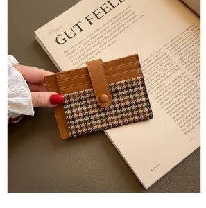 Detail shot of mini PU leather card holder with houndstooth pattern and snap closure.
