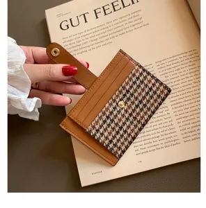 Minimalist ultra-thin card holder with chic houndstooth pattern and leather detailing, detail view.