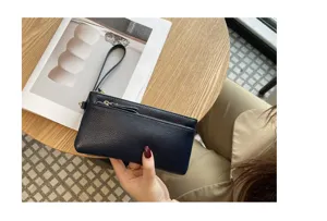 Dark blue leather wristlet wallet detail view, portable zipper clutch with multi compartments