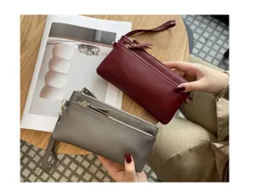 Close-up view of genuine leather long clutch bag, multi-zipper pocket and phone purse.