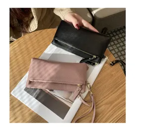 Top layer cowhide women's long clutch bag with zipper and wrist strap for daily portable use.