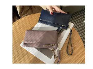 Genuine leather clutch purse for women, portable multi-zipper wristlet wallet and phone bag.