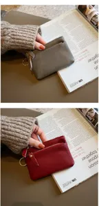 Genuine leather mini coin purse with zipper and keyring, compact design for women's daily use.