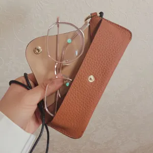 Genuine leather neck-hanging glasses case with strap, premium portable storage pouch.