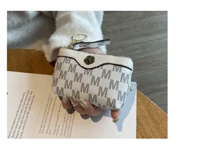 Women's mini white coin purse with M monogram pattern, cute flower button and zipper.
