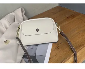 Detail view of the premium leather shoulder bag with chic contrast strap and flap design.