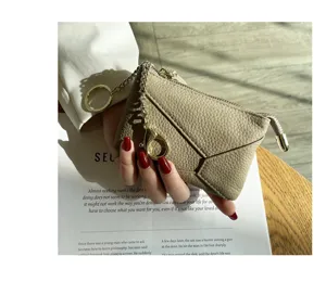 Genuine leather coin purse detail view, soft cowhide zipper key pouch in light khaki.
