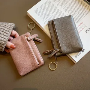 Genuine leather mini coin purse for women, cute key holder with multi-layer zipper and compact design.