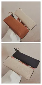 Detailed view of top-layer cowhide leather glasses pouch with lanyard and metal ring.