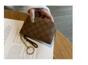 Mini brown monogram coin purse with zipper and short chain keychain for women daily use.