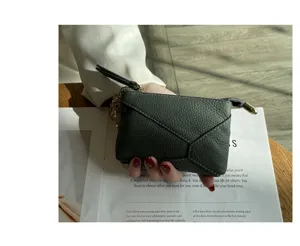 Genuine leather coin purse detail, soft cowhide zipper wallet with geometric stitching.