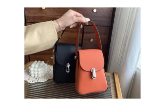 Detailed view of genuine leather phone bag handle and distinctive metallic lock closure design.