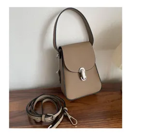 Leather phone bag detail view, casual crossbody style, adjustable strap, daily use.