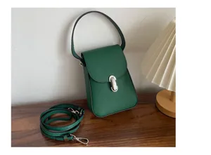 Detailed view of the dark green genuine leather mini crossbody bag, showcasing textured cowhide.