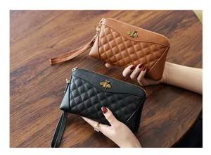Genuine leather women's clutch wallet featuring quilted design, metal bee decor and wrist strap.