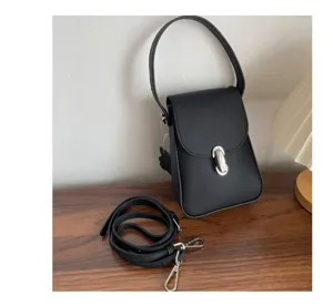 Minimalist black genuine leather crossbody phone bag with top handle and metal clasp design.