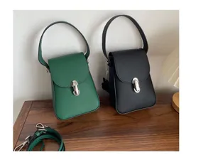 Detailed view of genuine leather small handbag, classic retro style with detachable shoulder strap.