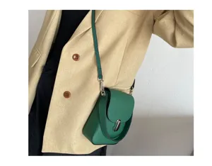 Green leather phone bag detail, compact crossbody design with metal lock and shoulder strap.