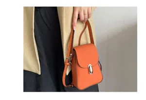 Genuine leather mini crossbody bag for women, orange pebble grain phone bag with metal lock.