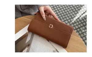 Brown leather long wallet for women with elegant clover clasp, premium pebble grain cowhide.