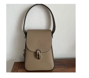 Genuine leather mini phone bag detail showing premium texture and silver lock hardware.