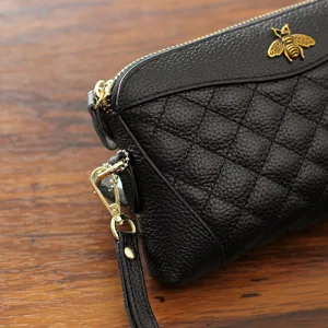 Genuine leather women's quilted clutch wallet with bee decor and wrist strap, main view.