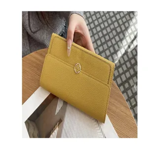 Yellow long genuine leather wallet for women with elegant flower metal clasp detail.
