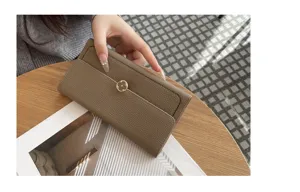 Genuine leather long wallet for women, premium cowhide clutch purse with floral clasp detail.