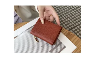 Compact brown leather trifold wallet for women with secure coin pocket and RFID blocking protection.