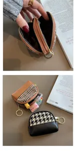 Detail view of the houndstooth double zipper coin purse, showing compact interior structure.