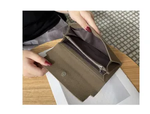 Close-up view of the genuine leather long wallet interior, showing compartments and zipper.