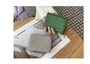 Compact genuine leather trifold wallet for women with multiple card slots and coin pocket.
