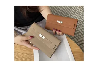 Premium genuine leather long wallet for women with classic turn lock closure, elegant clutch bag.
