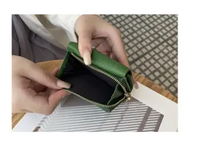 Green mini genuine leather tri-fold wallet detail showcasing coin pocket and inner lining