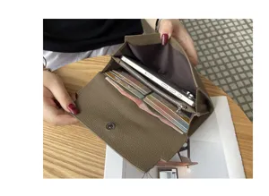 Genuine leather long wallet for women, multifunctional clutch bag with card slots and phone pocket.
