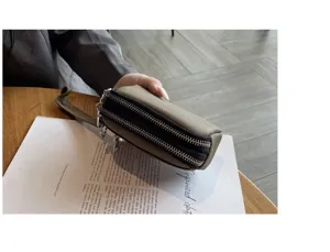 Women's mini genuine leather double zipper coin purse clutch detail view, compact wristlet.