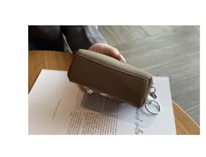 Detail view of genuine leather mini key pouch wallet with double zippers and ring hook.