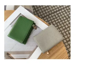 Mini tri-fold leather wallet detail view, showing green and gray colors with texture.