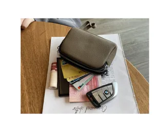Compact genuine leather mini coin purse with double zippers, versatile small wristlet bag.