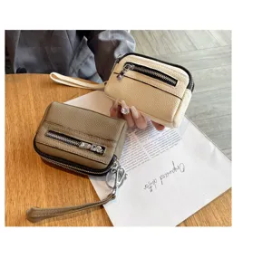 Mini genuine leather coin purse with double zippers, wrist strap and key ring for women.