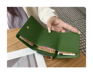 Detailed view of the green leather trifold wallet showing interior card slots and coin pocket.
